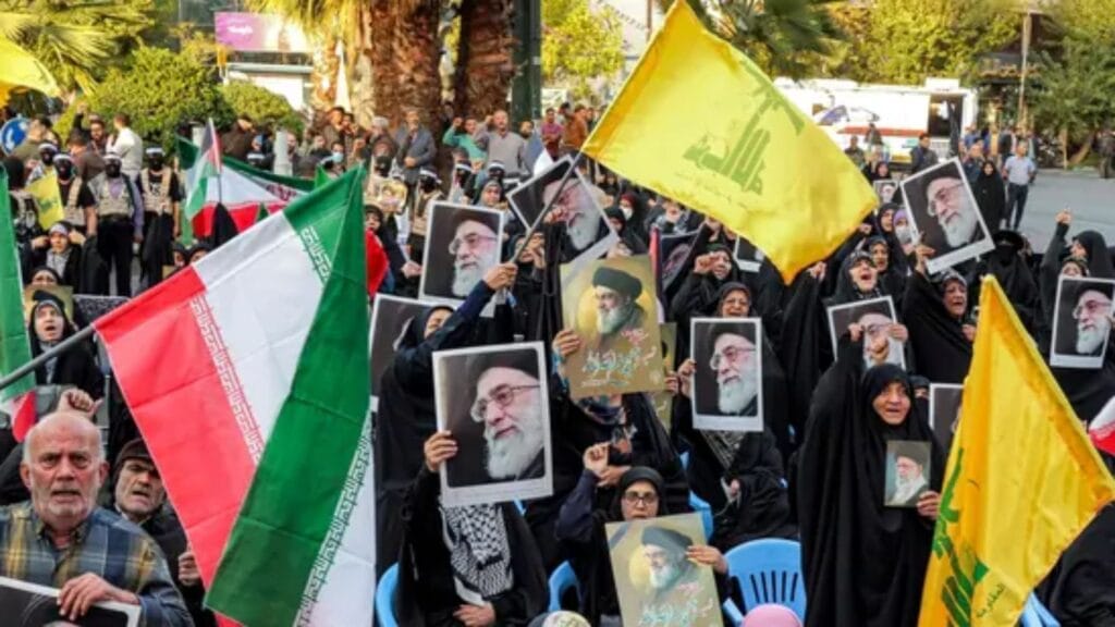 Protesters in Tehran wave Iranian flags, Hezbollah flags, and hold images of Supreme Leader Ayatollah Ali Khamenei during an anti-Israel rally on October 24, 2024.